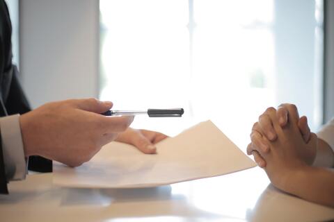 Businessman giving person contract to sign